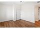 Bright and spacious bedroom featuring wood floors, neutral walls, and double closets at 10619 W Sells Dr, Phoenix, AZ 85037