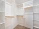 Walk-in closet with wood rods and shelves for optimal storage at 10619 W Sells Dr, Phoenix, AZ 85037
