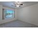 Bright bedroom with large window and neutral carpet at 1491 W Blue Ridge Way, Chandler, AZ 85248