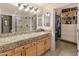 Bathroom featuring granite countertops, dual sinks, and a separate shower with a glass door at 15221 N Clubgate Dr # 1138, Scottsdale, AZ 85254