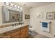 Well-lit bathroom with a granite countertop vanity, framed mirror, and tiled floor at 15221 N Clubgate Dr # 1138, Scottsdale, AZ 85254