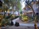 View of landscaped condo community with winding path, greenery, and mature trees at 15221 N Clubgate Dr # 1138, Scottsdale, AZ 85254