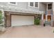 Spacious two car garage with brick paved drive, covered by a white pergola in a gated community at 15221 N Clubgate Dr # 1138, Scottsdale, AZ 85254