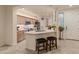 An open kitchen with modern appliances, a breakfast bar, and neutral-toned cabinetry at 15221 N Clubgate Dr # 1138, Scottsdale, AZ 85254