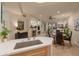 Open living room with stone fireplace, ceiling fan, and views of the dining area at 15221 N Clubgate Dr # 1138, Scottsdale, AZ 85254