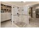 Luxurious walk-in shower with sleek glass door, stone tile surround, and mosaic tile floor at 15221 N Clubgate Dr # 1138, Scottsdale, AZ 85254