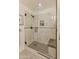 Stylish shower with a frameless glass door, rainfall shower head, and built-in shower seat at 15221 N Clubgate Dr # 1138, Scottsdale, AZ 85254