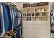 Spacious walk-in closet with custom shelving and drawers, perfect for organizing clothes and accessories at 15221 N Clubgate Dr # 1138, Scottsdale, AZ 85254