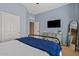 Comfortable bedroom with blue walls, a TV, and a view of the room at 1619 E Beretta Pl, Chandler, AZ 85286