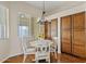 Charming dining area with a round table, stylish chairs, and a modern chandelier, complemented by natural light at 1619 E Beretta Pl, Chandler, AZ 85286