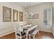 Cozy dining room with modern lighting and seating for six at 1619 E Beretta Pl, Chandler, AZ 85286