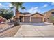 The exterior of this home has a two-car garage and well-maintained landscaping at 1619 E Beretta Pl, Chandler, AZ 85286