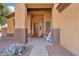 This is a front porch with nice decor and a white chair at 1619 E Beretta Pl, Chandler, AZ 85286