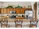 Open kitchen with bar seating and a view of the cooking area at 1619 E Beretta Pl, Chandler, AZ 85286