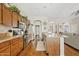 Spacious kitchen featuring stainless steel appliances, wood cabinets, and a functional island with tile countertops at 1619 E Beretta Pl, Chandler, AZ 85286