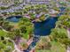 Gorgeous aerial view of the community lakes, waterfalls, and the surrounding green spaces and buildings at 1635 W Owens Way, Anthem, AZ 85086