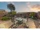 Outdoor space showcasing a patio with seating, desert landscaping, and a private, fenced yard at 1635 W Owens Way, Anthem, AZ 85086
