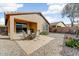 Outdoor patio with table and chairs, gravel landscaping, and block wall at 1635 W Owens Way, Anthem, AZ 85086