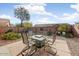 Charming backyard featuring decorative rock, a stone patio, and an outdoor dining set at 1635 W Owens Way, Anthem, AZ 85086