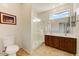 Bright bathroom featuring a glass-enclosed shower, double sink vanity, and tile flooring at 1635 W Owens Way, Anthem, AZ 85086