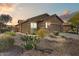 Charming single-story home boasts desert landscaping, stone accents, and an attached two-car garage at 1635 W Owens Way, Anthem, AZ 85086