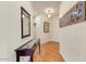 Hallway with wood floors, a console table, and decorative wall art, creating a welcoming entrance at 1635 W Owens Way, Anthem, AZ 85086