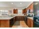 Well-appointed kitchen featuring wood cabinetry, stainless steel appliances, and a breakfast bar at 1635 W Owens Way, Anthem, AZ 85086