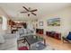 Open-concept living room features wood floors, neutral walls, and seamless flow into the dining and kitchen areas at 1635 W Owens Way, Anthem, AZ 85086