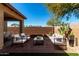 Inviting backyard area with outdoor seating, a cozy fire pit, and lush greenery at 16848 W Bradford Way, Surprise, AZ 85374