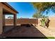 Charming backyard featuring a custom stone patio, fire pit, and desert landscaping at 16848 W Bradford Way, Surprise, AZ 85374