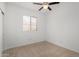 Bedroom with neutral carpet, ceiling fan, a window and a closet at 16848 W Bradford Way, Surprise, AZ 85374