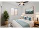 Bright bedroom with a queen bed, stylish decor, and a large window for natural light at 16848 W Bradford Way, Surprise, AZ 85374