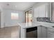 The kitchen features quartz counters, white cabinets, backsplash and tile flooring at 16848 W Bradford Way, Surprise, AZ 85374