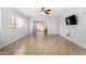 Large living room features a ceiling fan, neutral paint and arched doorways at 16848 W Bradford Way, Surprise, AZ 85374