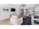 Bright living room with neutral palette, large windows, and a comfortable seating arrangement at 16848 W Bradford Way, Surprise, AZ 85374