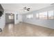 Bright open-concept living room with neutral paint and an arched doorway at 16848 W Bradford Way, Surprise, AZ 85374