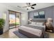Main bedroom with a king-sized bed, sliding door to backyard, and natural light at 16848 W Bradford Way, Surprise, AZ 85374