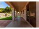 Relaxing covered patio overlooking a lush green lawn and desert landscaping at 16848 W Bradford Way, Surprise, AZ 85374