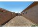 Spacious side yard with gravel, block walls, and a double-gated fence at 16848 W Bradford Way, Surprise, AZ 85374