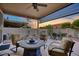 Outdoor covered patio with a seating area, featuring a round table and multiple comfortable chairs at 17675 N Coconino Dr, Surprise, AZ 85374