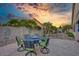 Well maintained backyard featuring an outdoor dining space and a lush garden with palm trees at 17675 N Coconino Dr, Surprise, AZ 85374