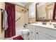 Bathroom featuring a shower-tub combo, white vanity, and decorative mirror at 17675 N Coconino Dr, Surprise, AZ 85374