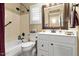 Cozy bathroom features a shower-tub combination, shutters, and a white vanity at 17675 N Coconino Dr, Surprise, AZ 85374