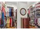 Walk-in closet with custom shelving and hanging rods for optimal organization and storage at 17675 N Coconino Dr, Surprise, AZ 85374