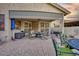 A cozy covered patio with outdoor seating and a textured concrete floor, perfect for entertaining or relaxing at 17675 N Coconino Dr, Surprise, AZ 85374