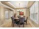 Formal dining room featuring a chandelier, large windows, and seating for six at 17675 N Coconino Dr, Surprise, AZ 85374