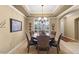 Dining area featuring a tray ceiling, chandelier, and seating for six guests at 17675 N Coconino Dr, Surprise, AZ 85374