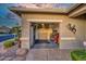 Open garage provides extra storage and workspace featuring a roll-up door and decorative lizard art on the exterior wall at 17675 N Coconino Dr, Surprise, AZ 85374