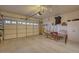 Spacious garage featuring ample storage, a roll-up door, and workbench for projects or hobbies at 17675 N Coconino Dr, Surprise, AZ 85374