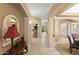 Elegant hallway with tile flooring, arched doorways, and a glimpse of multiple rooms at 17675 N Coconino Dr, Surprise, AZ 85374